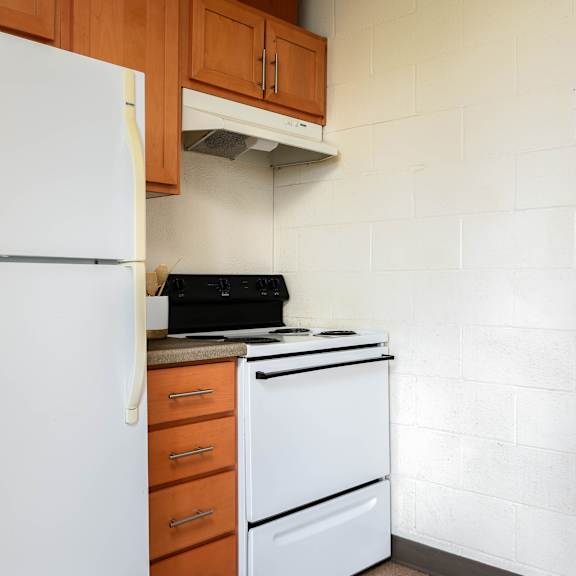 a kitchen with a white refrigerator and a stove