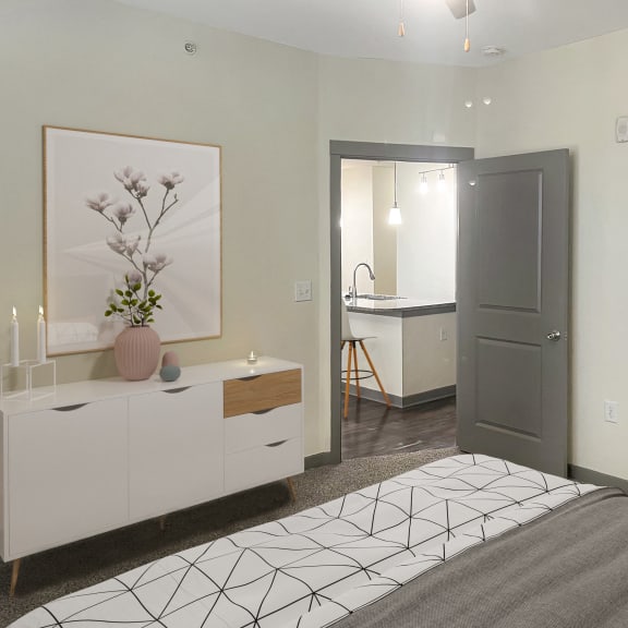 Thumbnail 5 of 5 a bedroom with a bed and a bathroom with a sink and a mirror