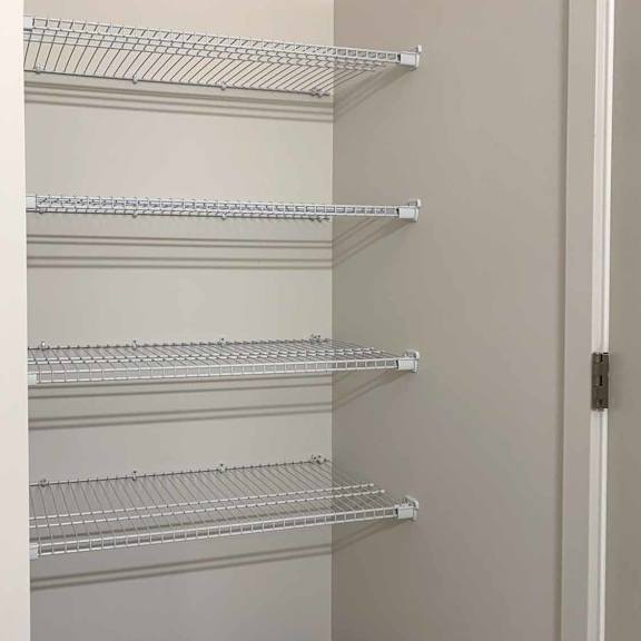 Thumbnail 21 of 22 a bathroom closet with built-in shelving
