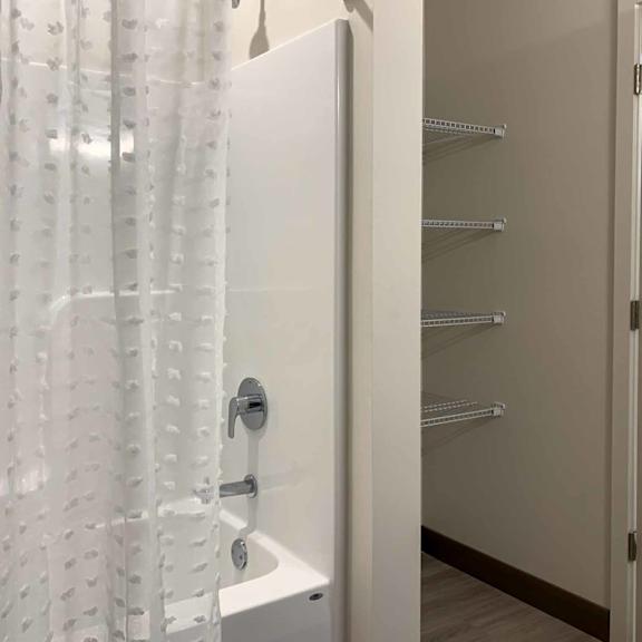 Thumbnail 22 of 22 a bathroom with a tub shower and a storage closet