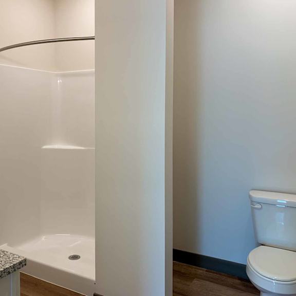 Thumbnail 36 of 36 a bathroom with a walk-in shower and a toilet