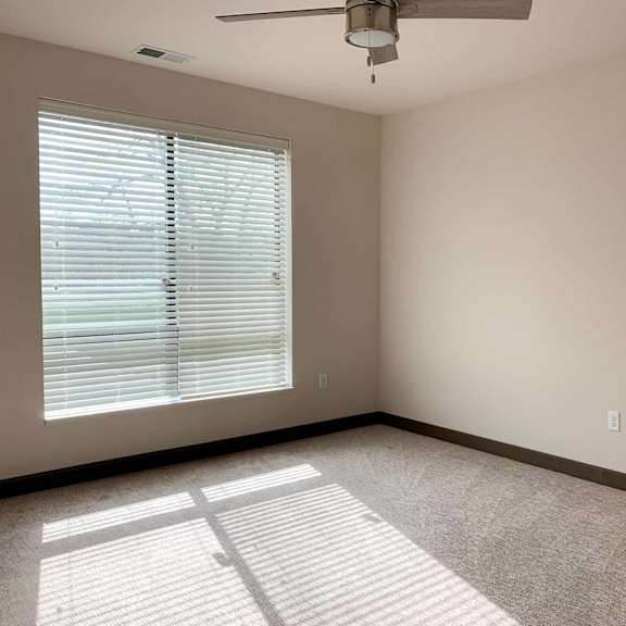 Thumbnail 34 of 36 a bedroom a window and ceiling fan