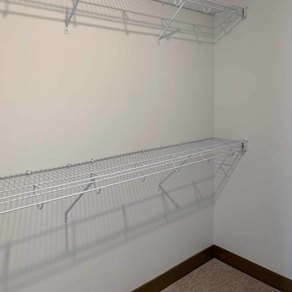 Thumbnail 32 of 36 a walk-in closet with built-in shelving and hanging space