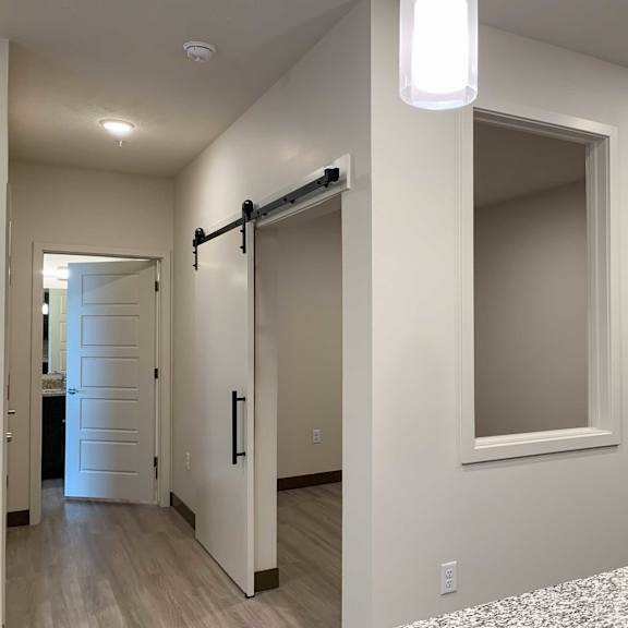 Thumbnail 6 of 15 a den with a sliding door and a small window
