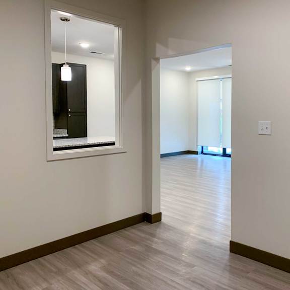 Thumbnail 8 of 15 the inside of a den with hardwood floors