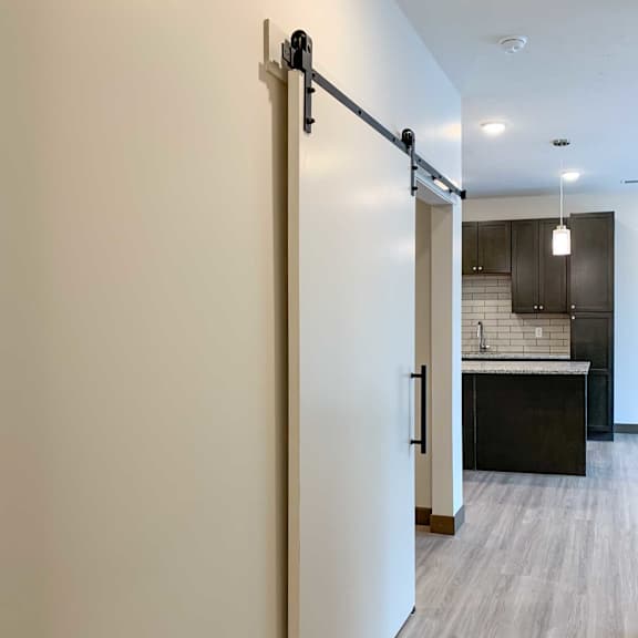 Thumbnail 9 of 15 a sliding door to the den next to the kitchen