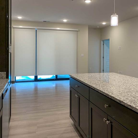 Thumbnail 5 of 15 a large kitchen island next to the living room
