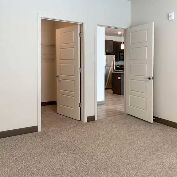 Thumbnail 7 of 13 a bedroom with a walk-in closet