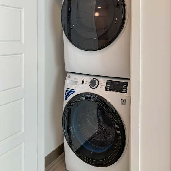 Thumbnail 13 of 13 a stackable washer and dryer in a closet