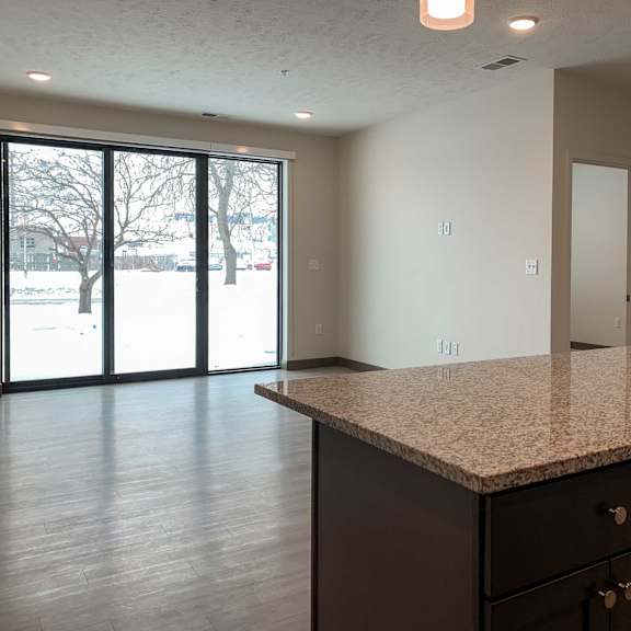 Thumbnail 6 of 13 the kitchen island overlooking the living room