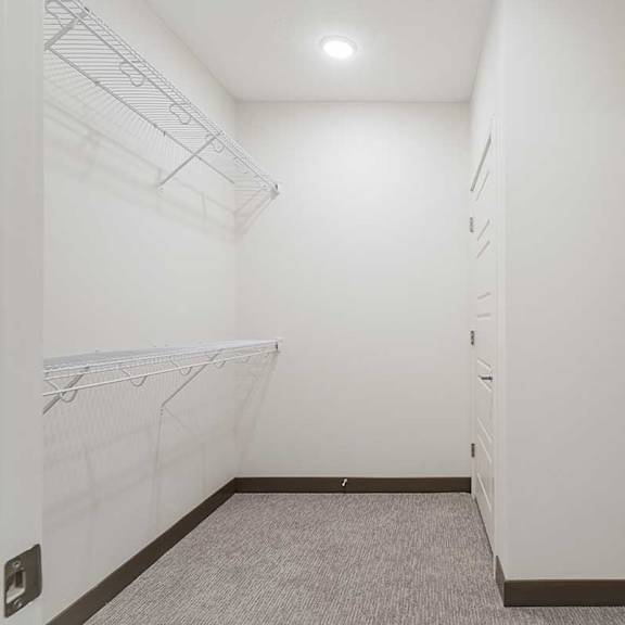 Thumbnail 17 of 29 a large walk in closet with built in shelving