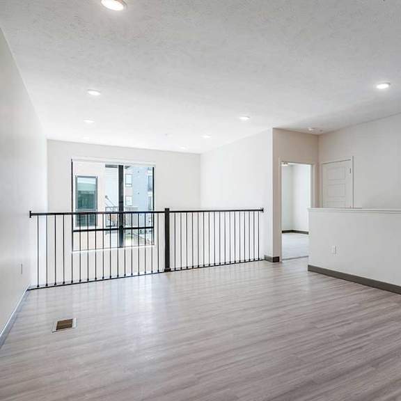 Thumbnail 20 of 29 an upper loft area with luxury vinyl tile flooring and a metal banister