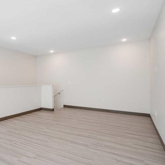 Thumbnail 19 of 29 a large living room loft space with luxury vinyl flooring