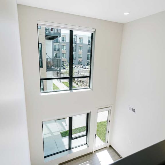 Thumbnail 21 of 29 a two-story wall in the living room with floor to ceiling windows