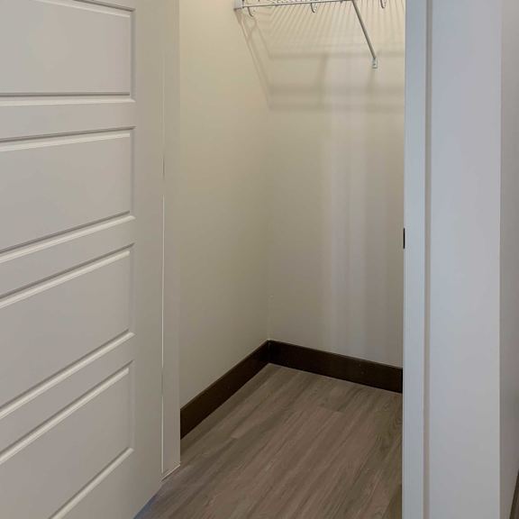Thumbnail 3 of 36 a coat closet with shelves on the wall