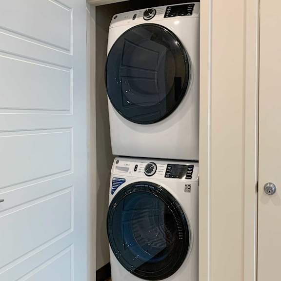 Thumbnail 4 of 36 a stackable washer and dryer in a closet