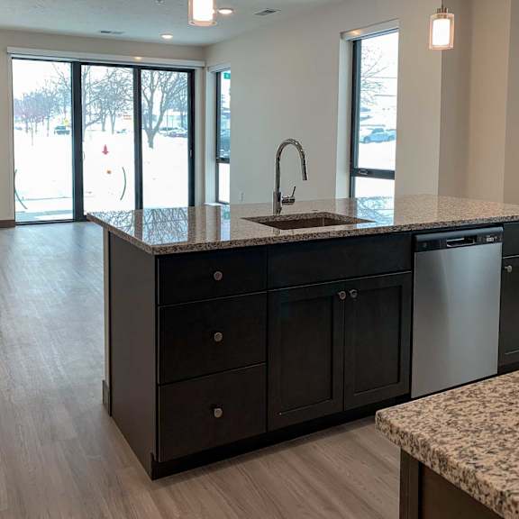 Thumbnail 8 of 36 a large kitchen with a sink and a counter top