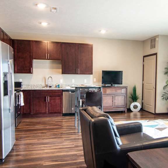 Thumbnail 4 of 19 Open layout with living room and kitchen with stainless steel appliances at 360 at Jordan West best new apartments West Des Moines IA 50266