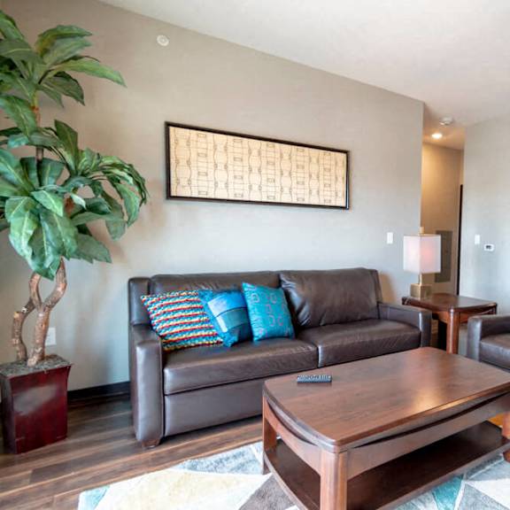 Thumbnail 10 of 19 a living room with leather furniture and a coffee table