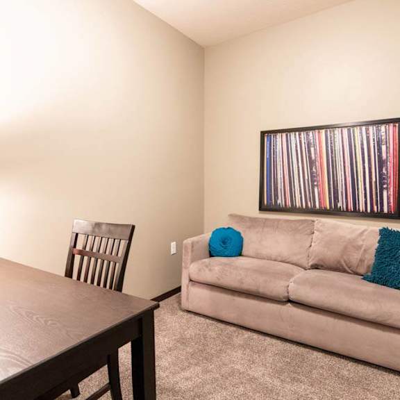 Thumbnail 17 of 19 A room with a couch, chair, and a picture on the wall.