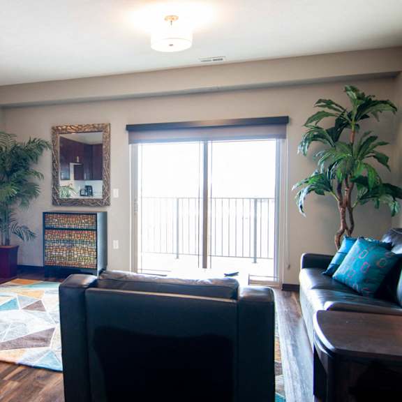 Thumbnail 5 of 19 Living room with large glass doors providing lots of natural light at 360 at Jordan West