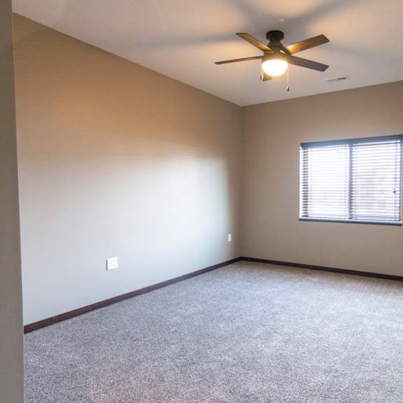 Thumbnail 15 of 18 Bedroom with ceiling fan and window providing natural light at 360 at Jordan West