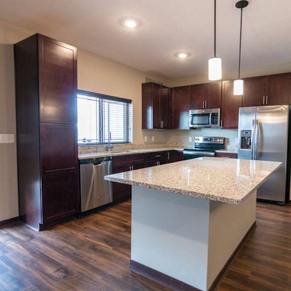 Thumbnail 6 of 18 Kitchen with updated stainless steel appliances and pendant lighting above the island at 360 at Jordan West