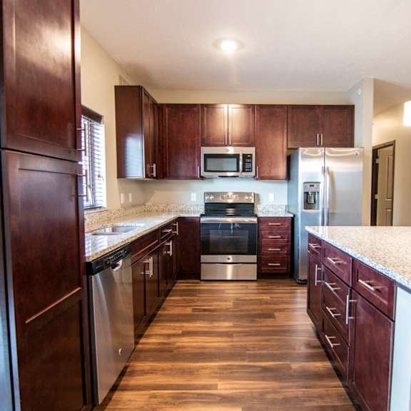 Thumbnail 7 of 18 Kitchen with large island and granite counter tops at 360 at Jordan West