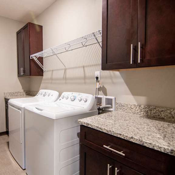 Thumbnail 9 of 18 Laundry room with storage space, counter space, and a washer and dryer at 360 at Jordan West