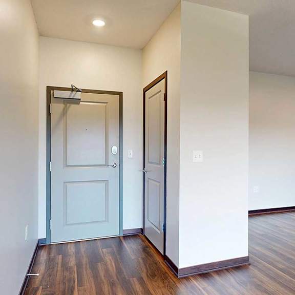 Thumbnail 3 of 26 A front entryway with a coat closet next to the front door.
