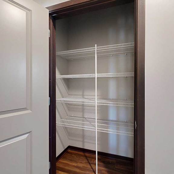 Thumbnail 4 of 26 A hallway closet with built-in wire shelving, perfect for linens.