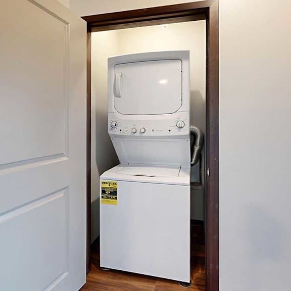 Thumbnail 26 of 26 A stacked full size washer and dryer in a closet.