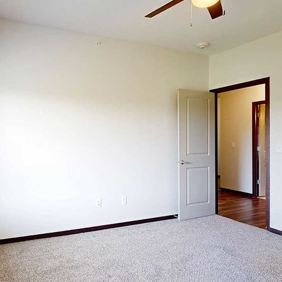 Thumbnail 20 of 29 A bedroom with a ceiling fan and large window for added natural light.