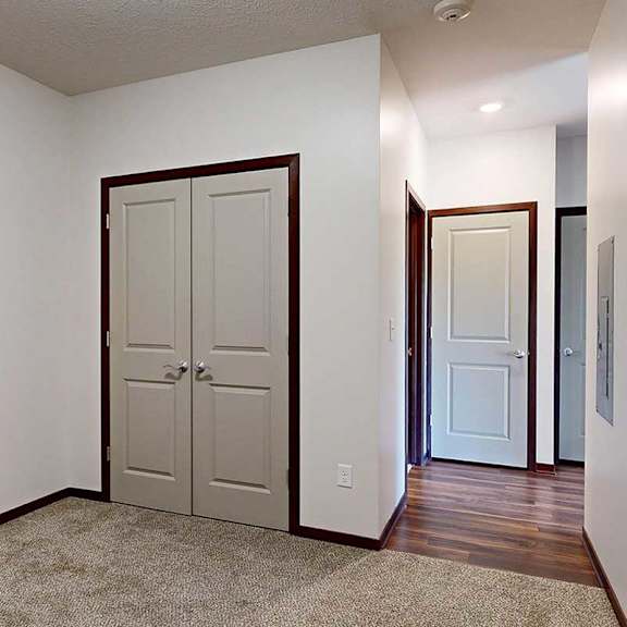 Thumbnail 24 of 29 A den space with a closet double-door closet, and an opening to the hallway.