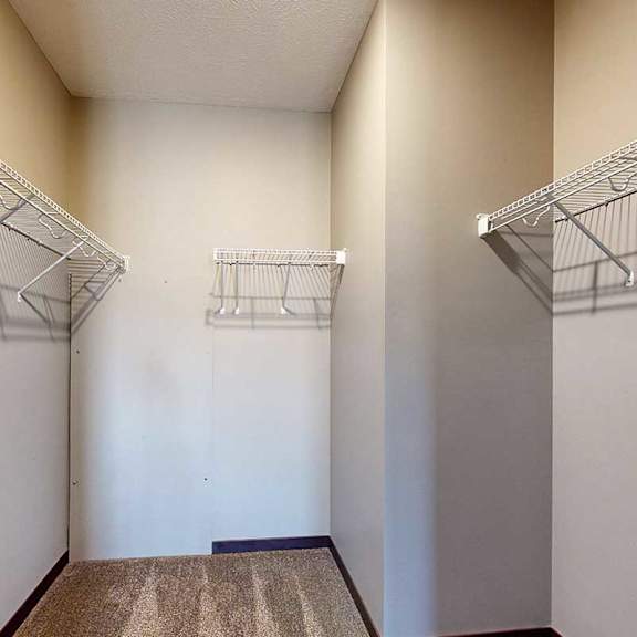 Thumbnail 28 of 34 An oversized walk-in closet with built-in wire shelves for storage.