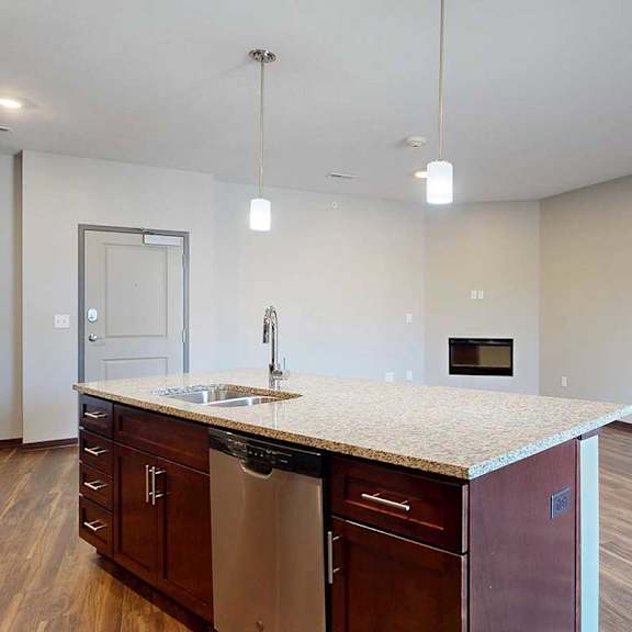Thumbnail 8 of 34 An open concept living room and kitchen, with a large central island.