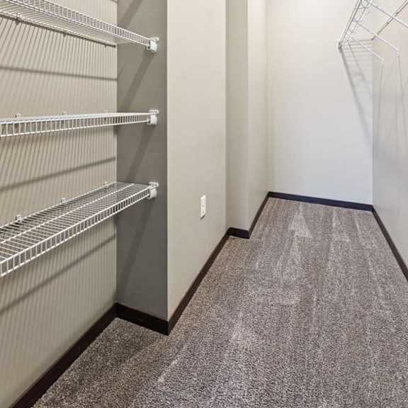 Thumbnail 16 of 18 An oversized walk-in closet with several built-in wire shelves.