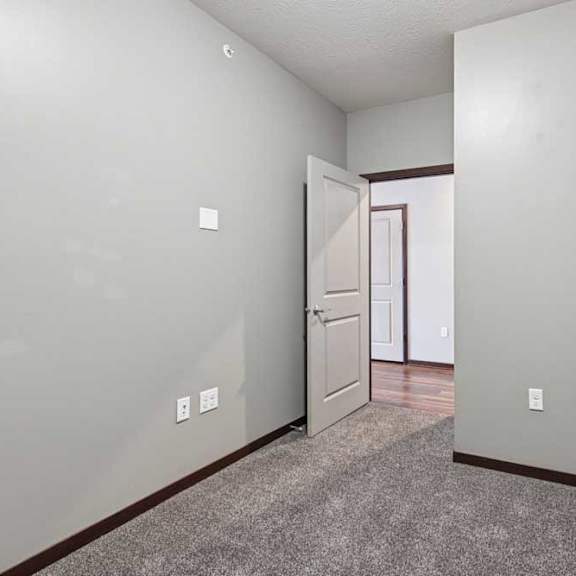 Thumbnail 33 of 34 A carpeted den space with several outlets.