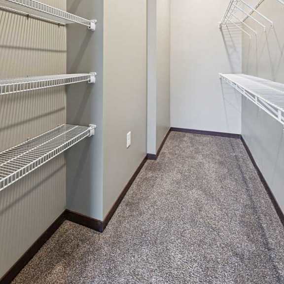 Thumbnail 21 of 23 An oversized walk-in closet with several built-in wire shelves.