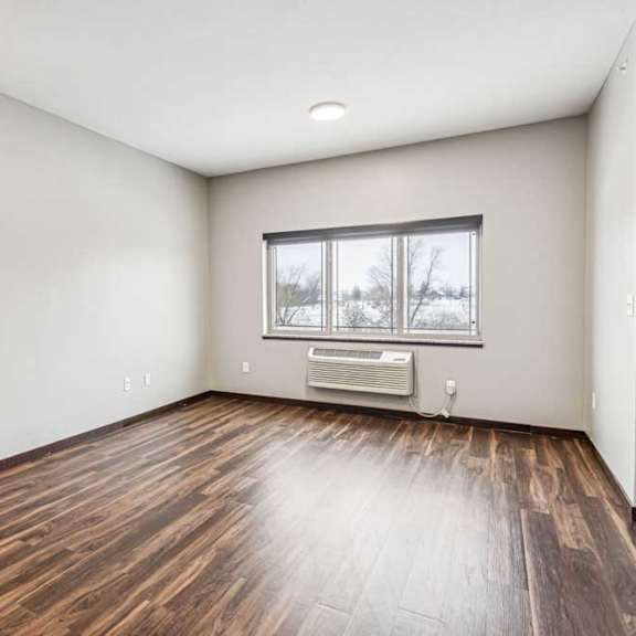 Thumbnail 9 of 15 A living area with a large, three-panel window.