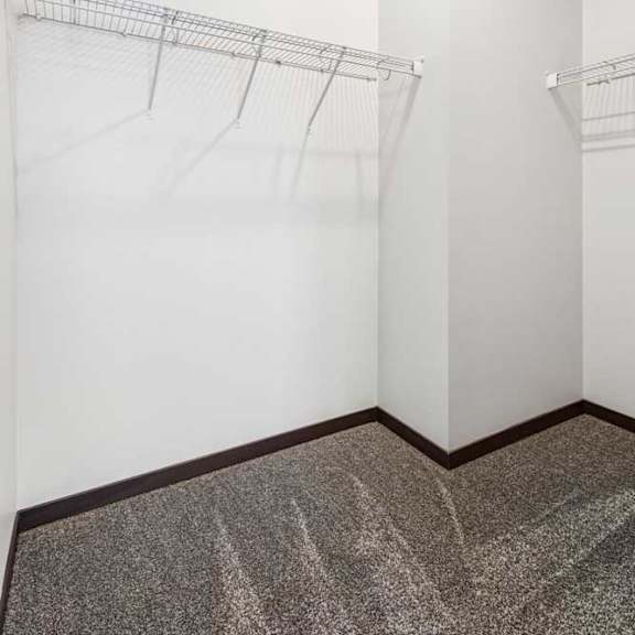 Thumbnail 20 of 21 An oversized walk-in closet with several built-in wire shelves.