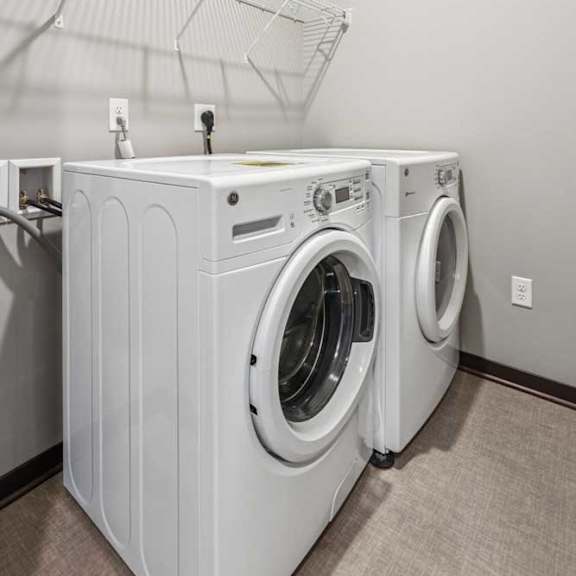 Thumbnail 17 of 21 A full-sized washer and dryer in a laundry room.