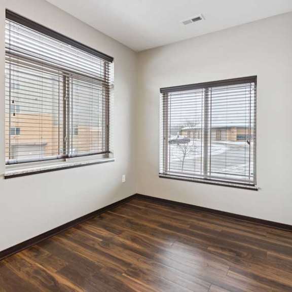 Thumbnail 7 of 19 A dining area with two oversized windows.