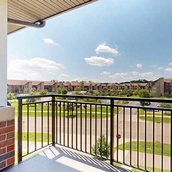 Thumbnail 6 of 27 A balcony with a metal railing, overlooking the neighborhood.