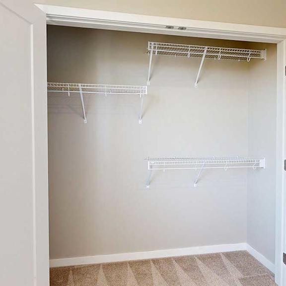 Thumbnail 26 of 27 A double-door closet with built-in wire shelving.