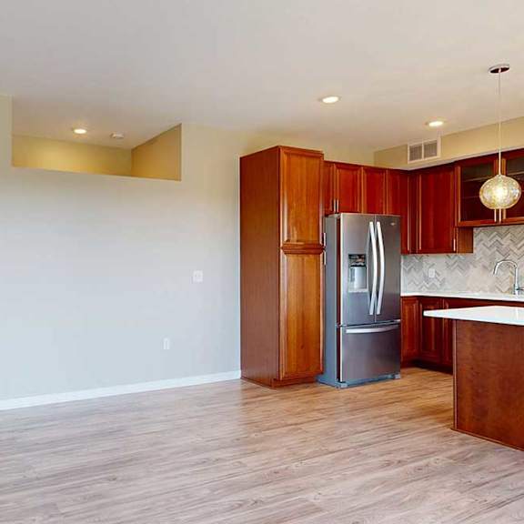 Thumbnail 24 of 27 A living room with hardwood-style flooring, and a view of the front entryway.