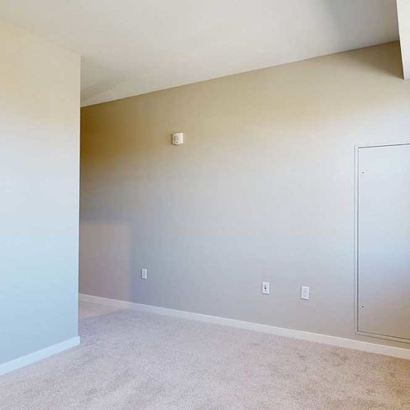 Thumbnail 21 of 29 A carpeted bedroom with a large window.