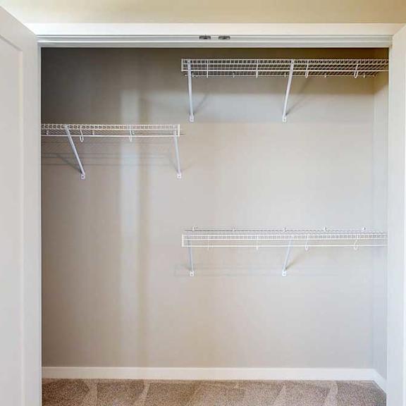 Thumbnail 26 of 29 A double-door closet with built-in wire shelves in the second bedroom.