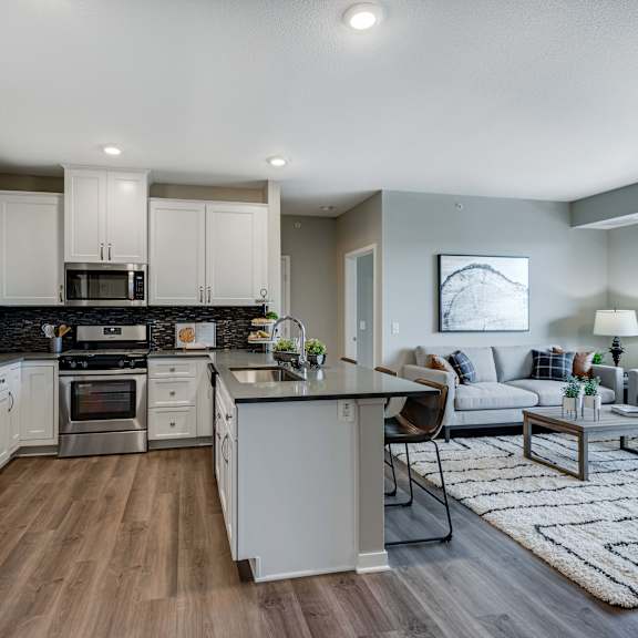 Thumbnail 2 of 19 Spacious kitchen with quartz counter tops and spacious living area of 2 bedroom apartment for rent at Ascend at Woodbury best new apartments Woodbury MN 55129