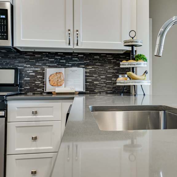 Thumbnail 7 of 19 gray quartz counters and premium faucet in premium white finish apartment